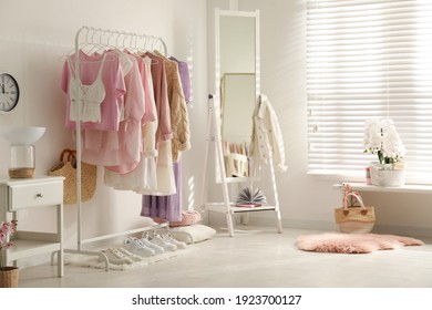 Dressing Room Interior With Clothing Rack And Mirror