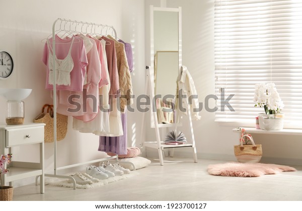 Dressing room\
interior with clothing rack and\
mirror
