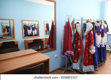 The Dressing Room In The Theater With A Large Mirror. Hanger With Multi-colored Stage Costumes