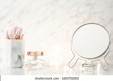 Dressing table with mirror on marble background.