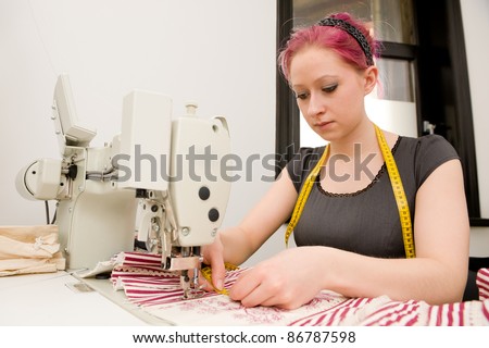 Dressmaker with sewing machine in her studio