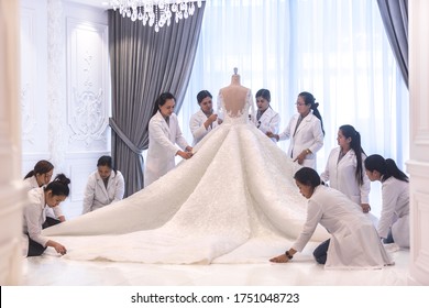 Dressmaking. Team Of Female Workers Making A Big Beautiful Haute Couture Bridal Wedding Dress. 