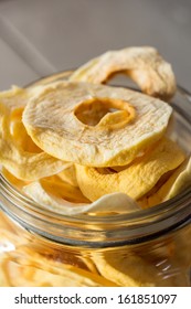 dried Apple Rings in a Jar on wooden Table
