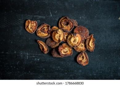 Dried apricots on rustic black table - Shutterstock ID 1786668830