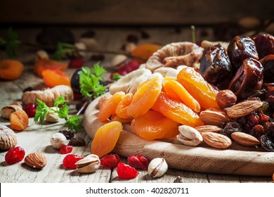 Dried apricots, set of nuts and dried fruits, vintage wooden background, selective focus - Powered by Shutterstock