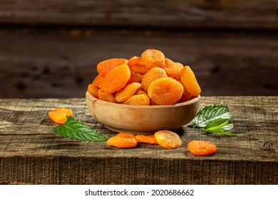 Dried Apricots In A Wooden Bowl On A Wooden Retro Board