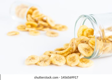 Dried Banana Slices In Glass Falling Isolated On White Background