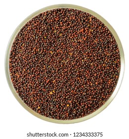 Dried Canola Seeds In A Glass Cup Isolated On White, Top View. Rapeseed Seeds In A Glass Cup. Black Brown Seeds For Germination. Canola Seeds Are Used In The Oil Industry To Produce Biodiesel.