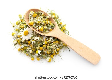 Dried chamomile flowers and wooden spoon on white background