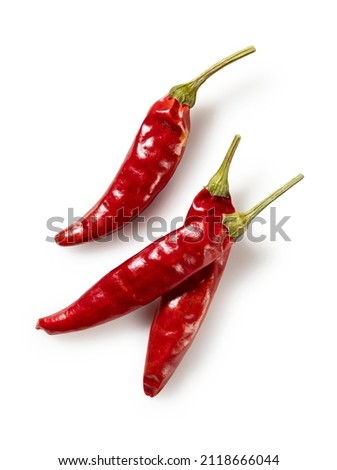 Dried chili peppers placed on a white background. View from directly above.