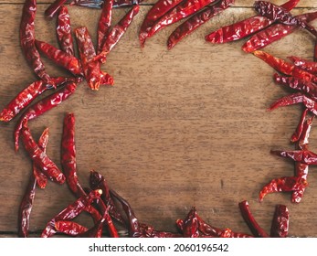 Dried Chili Photo Frame On Wooden Floor For Copy Space