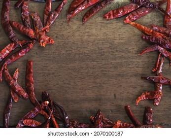 Dried Chili Photo Frame On Wooden Floor For Copy Space