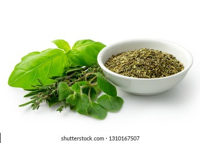 Dried Chopped Provence Herbs In A White Ceramic Bowl Next To Fresh Bouquet Garni Isolated On White.