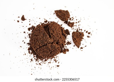 Dried coffee puck isolated on white background, soft focus close up