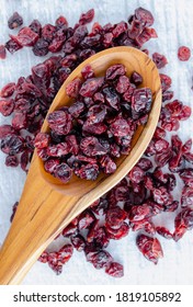 Dried Cranberries On Wooden Spoon.  Delicious And Healthy.  Overhead Vertical Composition.