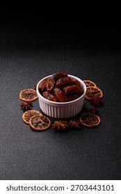 Dried dates in a ceramic plate, arabic food for the ramadan table. Dried dates as a food backdrop for your design.