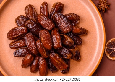 Dried dates in a ceramic plate, arabic food for the ramadan table. Dried dates as a food backdrop for your design.
