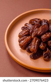 Dried dates in a ceramic plate, arabic food for the ramadan table. Dried dates as a food backdrop for your design.