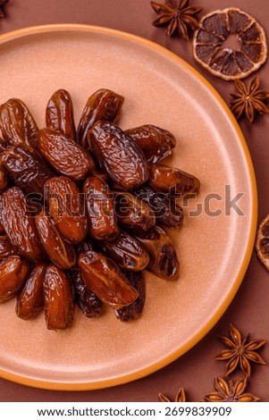 Dried dates in a ceramic plate, arabic food for the ramadan table. Dried dates as a food backdrop for your design.