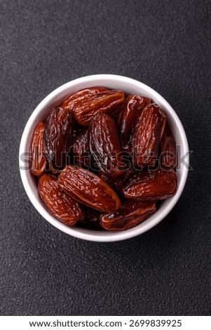 Dried dates in a ceramic plate, arabic food for the ramadan table. Dried dates as a food backdrop for your design.