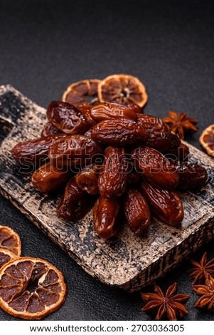 Dried dates in a ceramic plate, arabic food for the ramadan table. Dried dates as a food backdrop for your design.