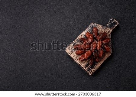 Dried dates in a ceramic plate, arabic food for the ramadan table. Dried dates as a food backdrop for your design.