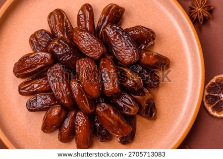 Dried dates in a ceramic plate, arabic food for the ramadan table. Dried dates as a food backdrop for your design.