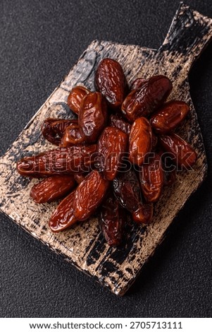 Dried dates in a ceramic plate, arabic food for the ramadan table. Dried dates as a food backdrop for your design.