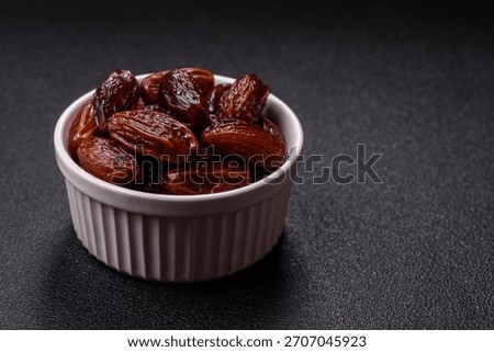 Dried dates in a ceramic plate, arabic food for the ramadan table. Dried dates as a food backdrop for your design.