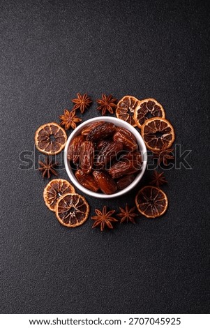 Dried dates in a ceramic plate, arabic food for the ramadan table. Dried dates as a food backdrop for your design.