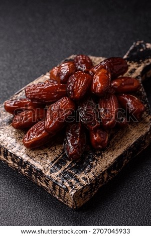 Dried dates in a ceramic plate, arabic food for the ramadan table. Dried dates as a food backdrop for your design.