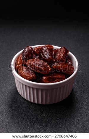 Dried dates in a ceramic plate, arabic food for the ramadan table. Dried dates as a food backdrop for your design.