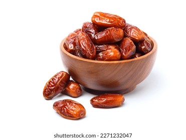 Dried dates fruits in wooden bowl isolated on white background.