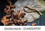  Dried dates and prayer beads.                             