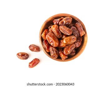 Dried dates in wooden bowl isolated on white background. Top view.