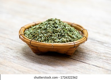 Dried fennel seeds, seeds in basket on a natural background.