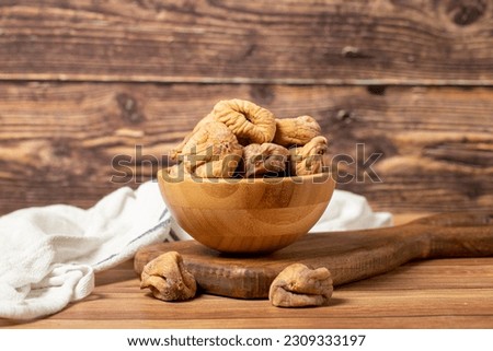 Dried figs in bowl. Organic farm products. Sun-dried figs on dark background