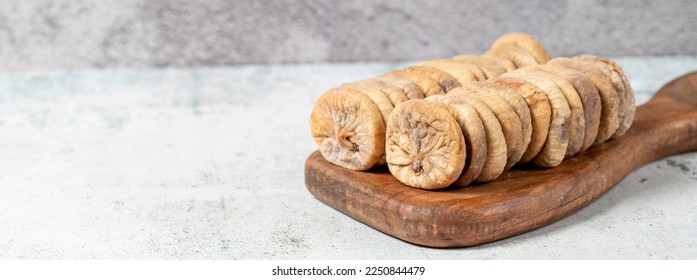 Dried figs on stone background. Special sun-dried dried figs on a wooden serving board. Diet foods. close up - Powered by Shutterstock