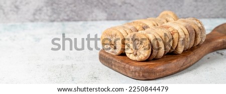 Dried figs on stone background. Special sun-dried dried figs on a wooden serving board. Diet foods. close up