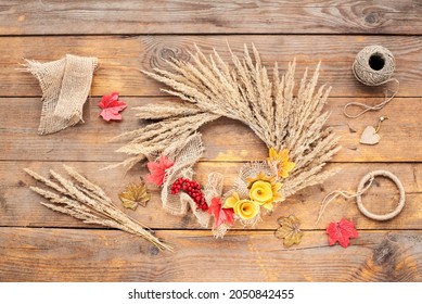 Dried Floral Wreath, Autumn Rustic Wreath With Dry Grass, Wildflowers  On Rustic Wooden Table. Floral Autumn Door Wreath From Natural Materials. Fall Flower Decoration Workshop. Top View