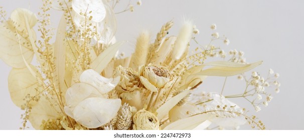 Dried flowers bouquet composition on light background banner.Copy space.Beige, boho style decor. - Powered by Shutterstock