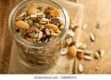 Dried Fruit And Nuts Trail Mix With Almonds, Raisins, Seeds And Apples In A Glass Jar