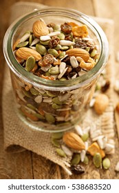 Dried Fruit And Nuts Trail Mix With Almonds, Raisins, Seeds And Apples In A Glass Jar