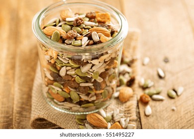 Dried Fruit And Nuts Trail Mix With Almonds, Raisins, Seeds And Apples In A Glass Jar