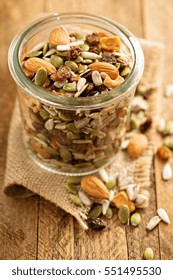 Dried Fruit And Nuts Trail Mix With Almonds, Raisins, Seeds And Apples In A Glass Jar