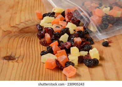 Dried Fruit Spilling Out Of The Bag On A Wooden Table