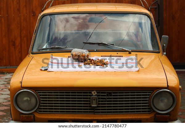 Dried fruits drying on\
the sun on a car 