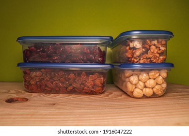 Dried Fruits And Nuts In Plastic Container For Food Storage. Raisin, Cranberry, Fig, Walnuts, Hazelnut.