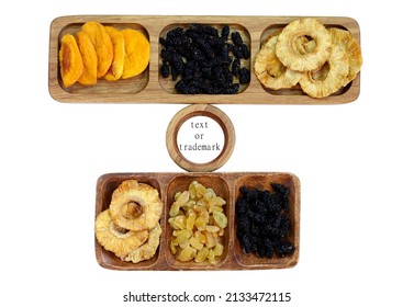 Dried Fruits On Wooden Plates. Dried Peach, Mulberry, Raisin And Pineapple. Between Them Is A Plate With Space For Text Or A Trademark. Isolated On White Background.