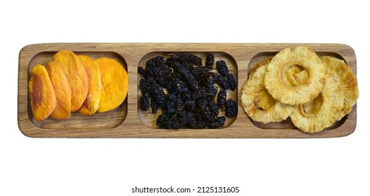 Dried Fruits On A Wooden Platter Divided Into Sections. Dried Peach, Mulberry And Pineapple. Isolated On White Background.